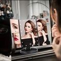A model using the LED Touch-Screen Makeup Mirror in and indoor environment.
